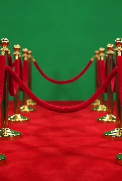 Red Carpet Entrance with Velvet Ropes and Golden Stanchions Against a Green Screen Background for Event Access and Celebrity Arrivals
