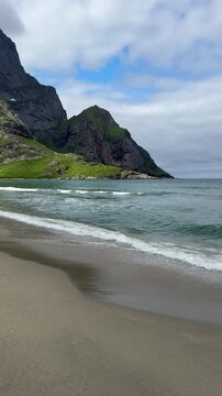 Вreathtaking view of Bunes Beach with white sand and turquoise water surrounded by majestic mountains, Lofoten Islands, Norway
