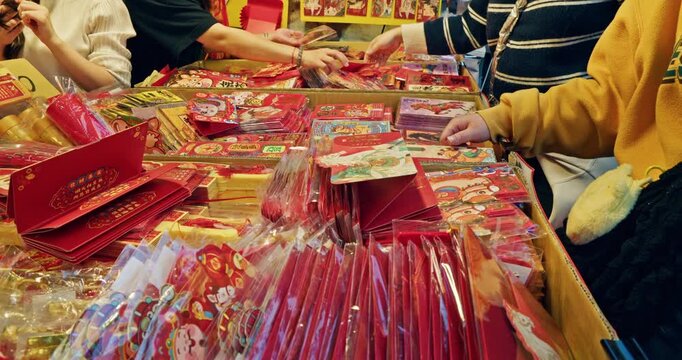Taipei, Taiwan, February 4, 2026: Customers select colorful red envelopes on Dihua Street on the eve of the Lunar New Year.
