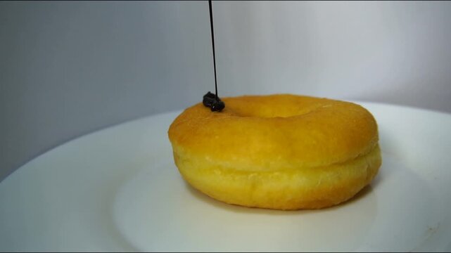 donuts being covered in delicious chocolate