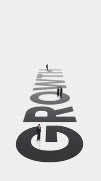 Tiny business people walking along growth word in stop motion animation. Concept of company development, scaling process, career progress, revenue increase and long term success.