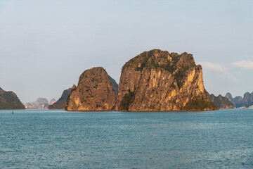 A view from a cruise ship towards Karst limestone islets in Ha Long Bay, Vietnam illuminated by the evening light © Nicola