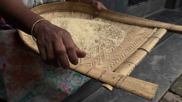 A housewife is cleaning rice for her family's daily meals.