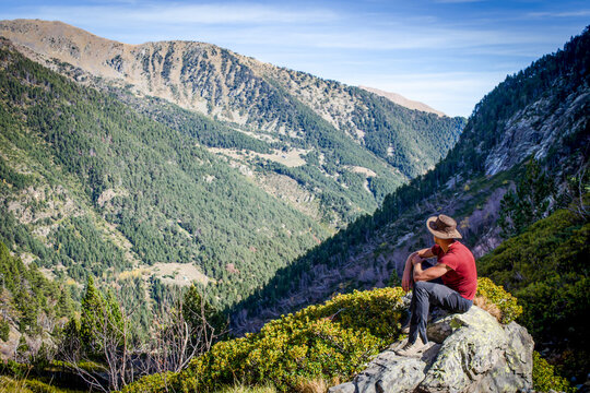 Hiker overlooking mountain valley in Coma Pedrosa Natural Park, Andorra