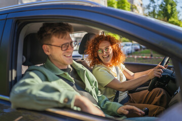 Happy couple driving car on a road trip