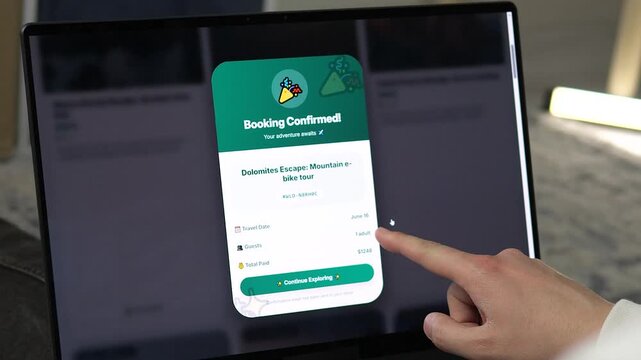 Plan your dream adventure. Close-up of a laptop screen showing a confirmed booking for a Dolomites mountain bike tour. High-quality visual for travel agencies, tourism marketing, and vacation planning