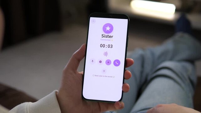 Tapping a smartphone to call a sister. The screen displays a simple contact interface. Perfect for family communication, connection apps, and personal relationships.