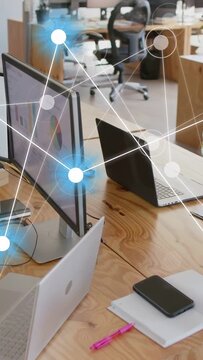 Vertical video: Desk monitor faint UI marker appearing, nodes forming and pulsing to show network