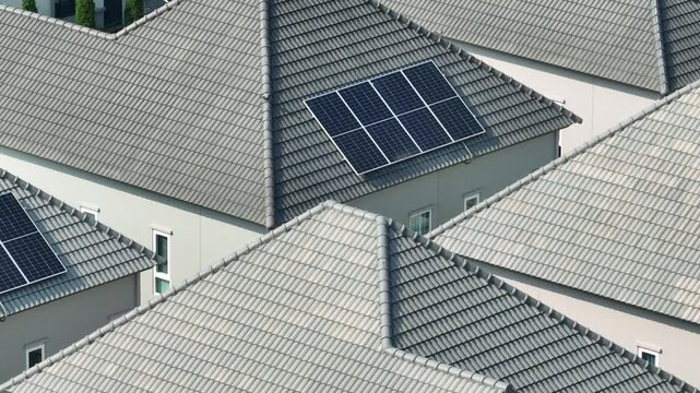 An aerial view of residential solar panels, emphasizing renewable energy transition, sustainable home design, lower energy bills, and positive environmental impact through clean electricity use. 4k.
