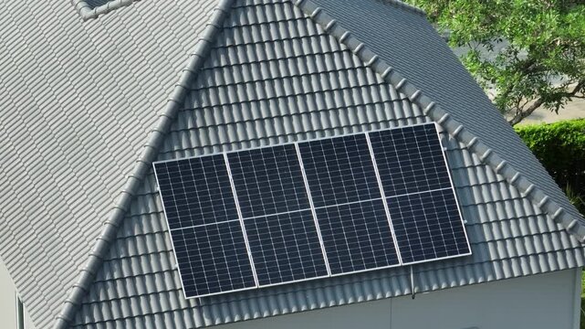 Drone captured rooftop solar panel system on modern house, showing green energy solution, carbon footprint reduction, long-term cost savings, and environmentally friendly power generation advantages.
