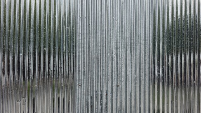 Shiny corrugated galvanized iron sheet texture. Contrast of old and new zinc sheets for industrial design. Vertical pattern of silver corrugated metal wall texture. Grunge zinc metal sheet background.