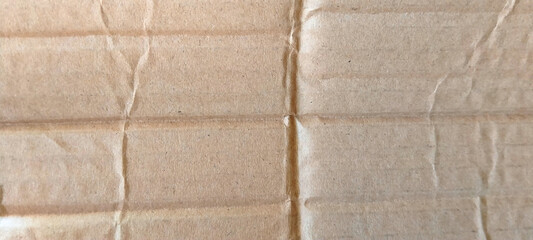Fototapeta premium Textured corrugated cardboard surface with natural brown color