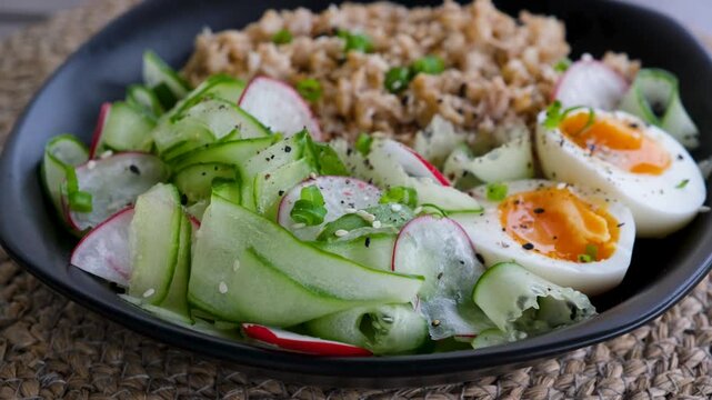 Close Up Spinning Plate with Grain Bowl and Fresh Salad
