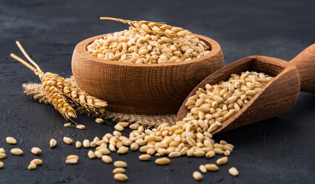 Wheat spikelets on a black stone background.