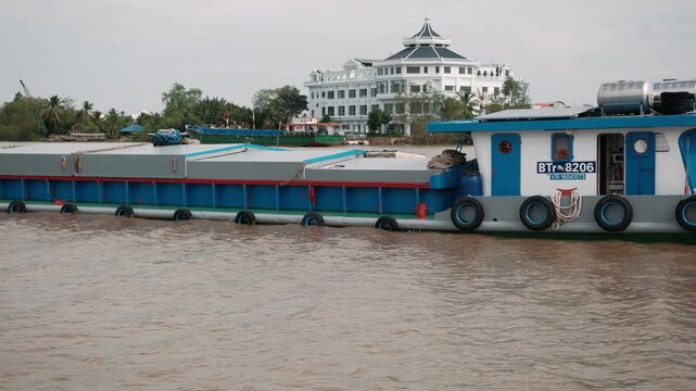 Vietnam cargo barge navigating the mekong river delta. River life and transportation in southeast asia