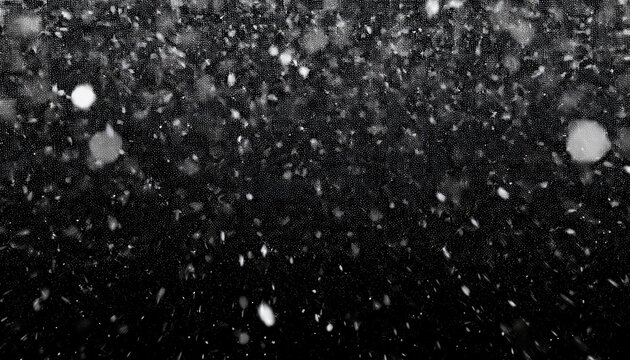 heavy snowfall effect with large blurred white snowflakes and smaller particles falling rapidly against an isolated black background
