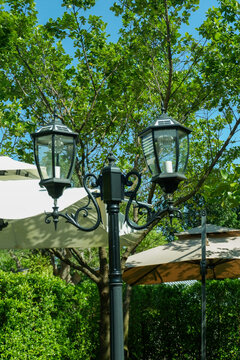 Lamp street in outdoor restaurant,Pendant light with matal lamps in street cafe,mountain view and sky,Simple home outdoor interior..