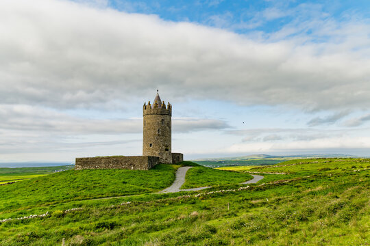 Doonagore Castle overlooking the Atlantic Ocean near Doolin, County Clare, Ireland. Historic 16th century tower house on the Wild Atlantic Way.