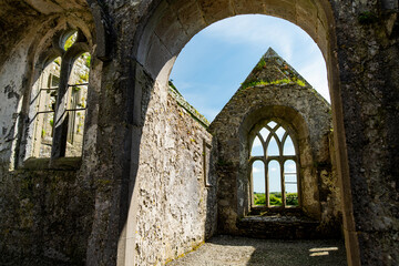 Naklejka premium Interior of Ross Errilly Friary near Headford, County Galway, Ireland. Atmospheric medieval Franciscan ruins with Gothic windows and stone tombs.