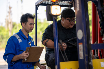 Industrial teamwork between forklift operator and warehouse mechanic inspection © Apichat