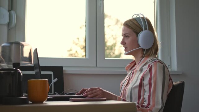 Customer service representative talking on a headset from her home office