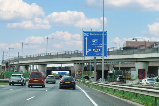 Netherlands - April 17, 2026: Daytime traffic on a motorway near Amsterdam approaching the Badhoevedorp junction and Amsterdam-Sloten exit, featuring a variety of vehicles