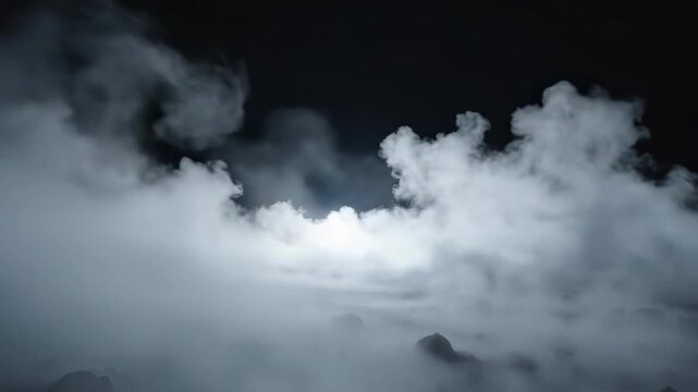 Thick white fog and smoke rolling over a dark rocky ground at night under a mysterious light.