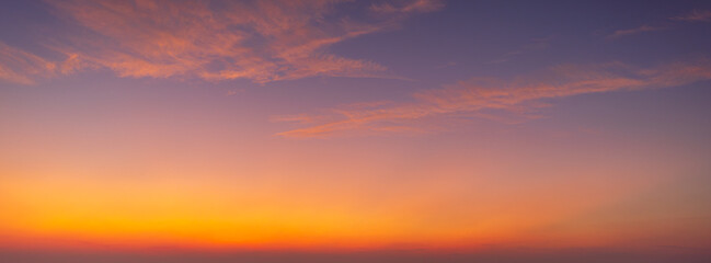 Fototapeta premium Panoramic vibrant sunset sky with colorful gradient clouds,A breathtaking panoramic view of the twilight sky during sunset, featuring a dramatic gradient of colors from deep purple and violet to warm 
