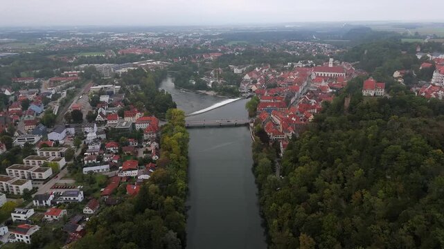 Upper Bavaria Germany seen from above in Landsberg am Lech with the Lech River, Karolinenbruecke and old town. The Karolinenwehr waterfall and fall foliage create a striking panoramic view.