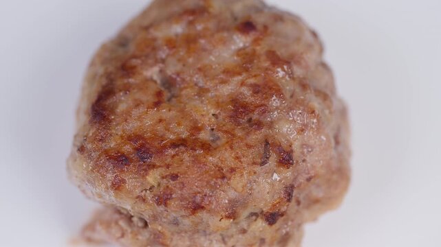 Closeup of seared homemade meat cutlet. Juicy interior with crispy exterior of cooked cutlet. Studio shot showcasing freshly cooked homemade meat cutlet with golden sear