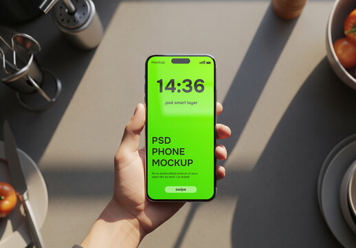 Hand holding a smartphone in a kitchen mockup