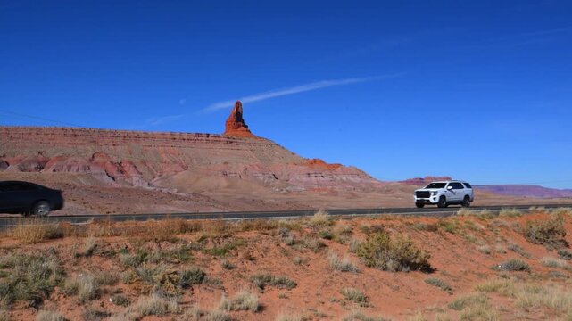 A scenic stretch of road in the American Southwest, likely near the Arizona-Utah border.