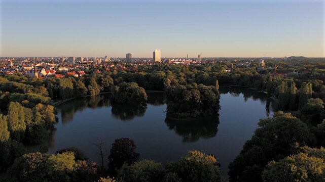 Aerial view of Kleinhesseloher See in the English Garden, Munich, Germany. Famous Bavarian park with lake, islands, nature and culture. Popular summer destination in central Europe