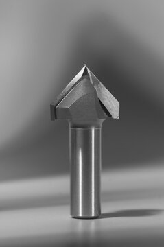 Sharp carbide tipped V-groove router bit for woodworking, professional CNC milling cutter tool close-up