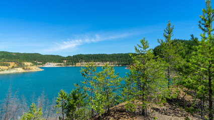 Fototapeta premium Abandoned Lipovsky nickel quarry near of city Rezh, Sverdlovsk region, the Urals with turquoise water in Lipovskiy Geological Park. Natural and mineralogical reserve Rezhevskoy