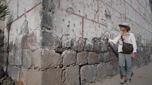 Mature woman explores Mission Church in San Ignacio, Baja California, Mexico while enjoying the local culture and history during her trip