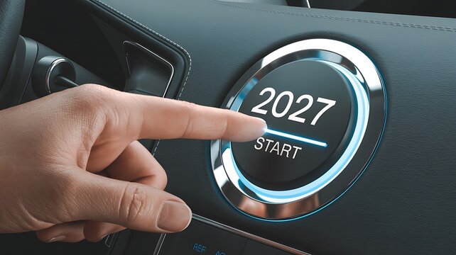 Hand presses start button on car dashboard with 2027 glowing, representing new beginning or future journey.