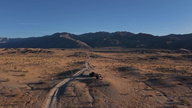 Teardrop camper and SUV navigate Thimble Trail in Anza Borrego Desert State Park in California while showing aerial views of the landscape.