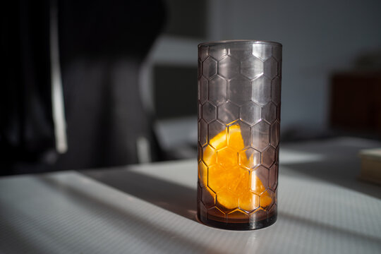Quiet office space adorned with orange hues and glass surfaces promoting peaceful productivity