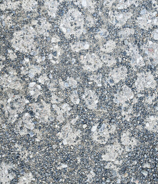 Weathered concrete texture background, aged cement with exposed aggregate and stones surface