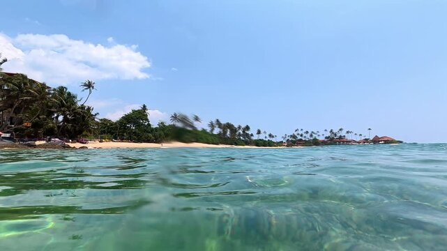 Tropical Beach Split View Above And Underwater Sri Lanka
Split underwater footage showing tropical beach coastline and clear ocean water Sri Lanka May 2026.
