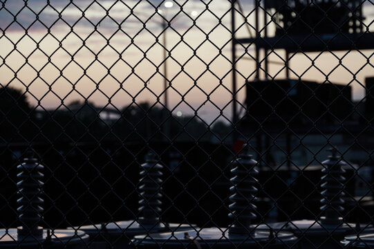 electrical transformers out of service industrial fence sunset bokeh