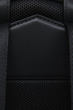 A close-up of a fashion bag against a white background. The texture of the leather and fabric