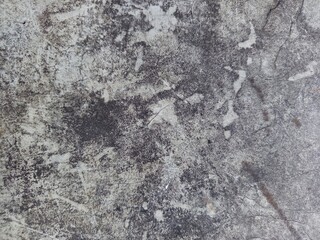 Top view close-up of a rustic dirt ground surface mixed with coarse sand, scattered white limestone...
