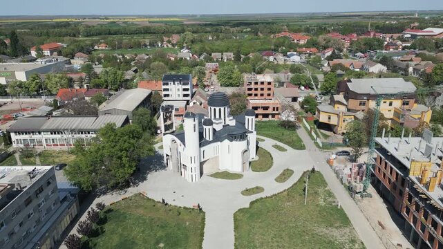Aerial view flying forward toward the Serbian Orthodox Church in town center of Vrbas, northern Serbia.