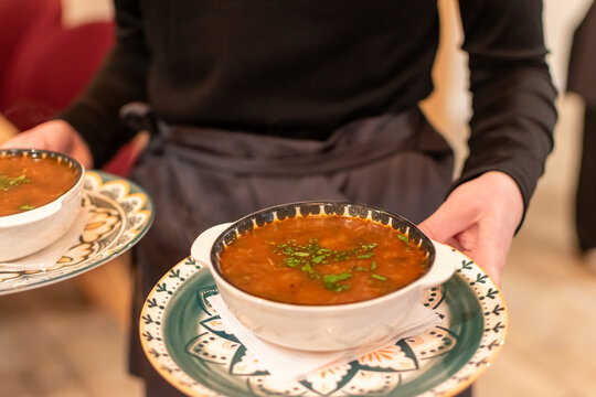 Traditional Georgian meat soup or stew served in a clay pot called ketsi. Authentic Caucasian cuisine with beef, vegetables, and fresh herbs. Hearty gourmet meal in a rustic restaurant setting