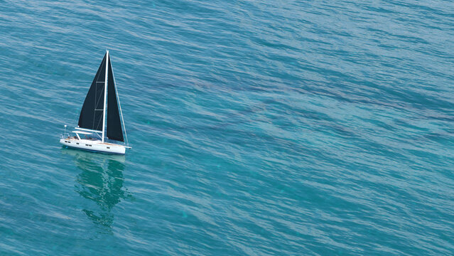 Luxury Modern Sailboat with Black Sails on Turquoise Tropical Sea - 3D rendering