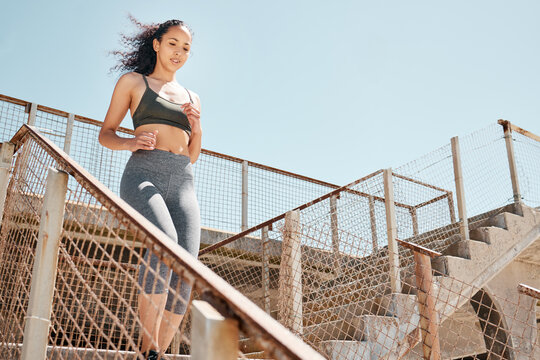 Running, sports and woman on steps in city for training, workout or practice for health in morning. Space, athlete and person on stairs in town for cardio exercise, active or wellness for fitness.
