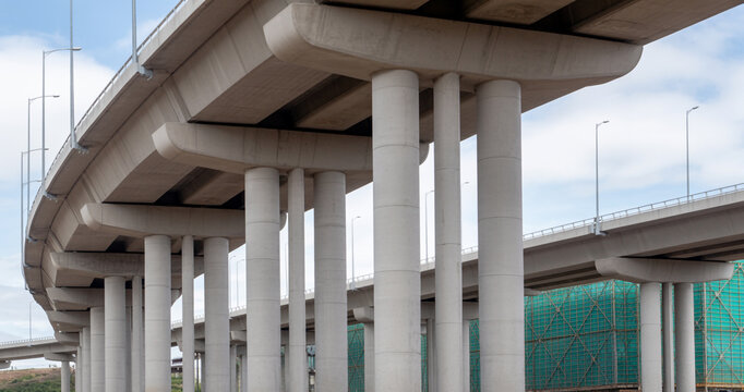 Modern concrete elevated highway with massive pillars supporting the structure