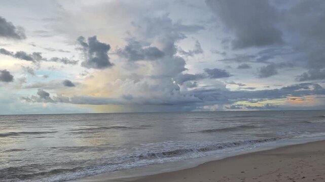 Calm Shoreline with Gentle Waves and Distant Rainstorm Under Moody Cloudy Sky, Cear&aacute;, Brazil 